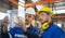 Engineer wearing safety helmet and glasses and explain the project diagram with manager in the manufacturing factory. Worker
