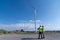 Engineer wearing uniform ,helmet inspection and survey work in wind turbine farms rotation to generate electricity energy. Green e