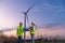 Engineer wearing uniform ,helmet inspection and survey work in wind turbine farms rotation to generate electricity energy. Green e