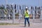 Engineer wearing uniform ,helmet inspection and survey work in wind turbine farms rotation to generate electricity energy. Green e