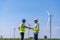 Engineer wearing uniform ,helmet inspection and survey work in wind turbine farms rotation to generate electricity energy. Green e