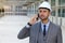 Engineer with white helmet calling by phone