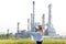 Engineer woman holding blueprint with radio for workers security control at power plant energy and petrochemical industry.