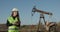 Engineer Woman Work on Digital Tablet. Portrait of Professional Female Engineer Wearing Safety Uniform and Hard Hat