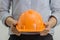 Engineer women hold orange hard safety helmet hat