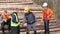 Engineer and workers discuss the quality of the timber before selling