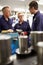 Engineer Working With Apprentices On Factory Floor