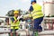 Engineer working in a oil refinery with talking on the portable radio for controlling work