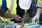 Engineer working repairing electric panel with solar panels background, Concept teamwork or training of renewable