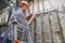 The engineer works in the server room of the data center. Cable laying in telephone exchange. A worker standing on the stairs