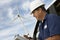 Engineer Writing On Clipboard At Wind Farm