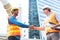 Engineer in Yellow helmet and best greeting with warm handshake manager visiting site. Modern construction and engineering concept