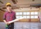 Engineering holding rolled blueprints in employment repair water leak drop interior office building under gypsum ceiling