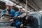 Engineering man wearing uniform safety workers perform maintenance in factory working machine lathe metal.