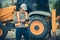 Engineering wearing a white safety helmet standing In front of the backhoe And are using tablet for check the blueprint with