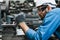 Engineering worker man wearing uniform safety and hardhat working machine lathe metal in factory industrial, worker manufactory