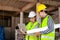 Engineers and construction contractors Holding a laptop to discuss building construction plans