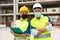 Engineers in face masks standing in construction plant