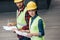 engineers in hardhats working with blueprint and clipboard