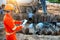 Engineers inspect the pouring of concrete with tablet