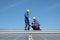 Engineers install solae cell on the roof of factory