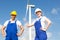 Engineers or installers posing in front of wind energy turbine