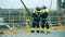 Engineers, in production plant as team discussing, industrial scene in background