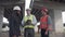 Engineers standing with bearded boss in white hard hat