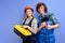 Engineers in uniform coveralls stand with tools instruments posing isolated on blue