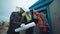 Engineers in a uniform near the electricity transformer