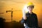 Engineers woman at construction site on background.