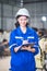 Engineers women mechanic holding check list on clipboard and pen in steel factory workshop. Industry robot programming software