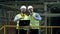 Engineers work with a laptop at a brick plant.