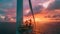 Engineers work on platform at wind turbine in sea, workers perform maintenance of windmill in ocean at sunset. Concept of energy,