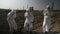 Engineers workers dressing protective hazmat clothes intoxicated with nuclear waste from near power plant falling down dying -