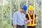 Engineers working meeting room with a tablet. Two workers are watching construction plan. at the office. Electricians carpenter or