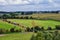 England lush pastures and farmlands in the United Kingdom. Beautiful English countryside with emerald green fields and meadows.