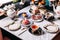 English afternoon tea set including hot tea, pastry, scones, sandwiches and mini pies on marble top table