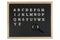 English alphabet letters on blackboard and magnifying glass. Education concept