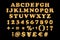 English alphabetic fonts and numbers from yellow Golden font balloons on a black background. holidays and education