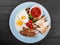 English breakfast - Fried eggs, beans, sausage, grilled tomatoes, mushrooms, toasted bread and sauce on plate