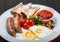 English breakfast - Fried eggs, beans, sausage, grilled tomatoes, mushrooms, toasted bread and sauce on plate