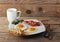 English Breakfast - scrambled eggs, bacon, fried toast and tea