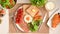 English breakfast set with egg, hams, sausages, toasts on table
