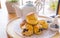 English breakfast and tea break. scones on wooden table with a cup of tea.