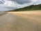 English coastline in Hampshire. Shingle beach with green backdrop.