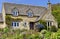 English Cotswolds cottage with flowering summer garden