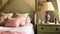 English cottage bedroom interior with pink and sage green decor