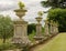 English country garden: Tall marble garden urn and hedge