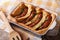 English food: toad in the hole into a baking dish close up. Horizontal